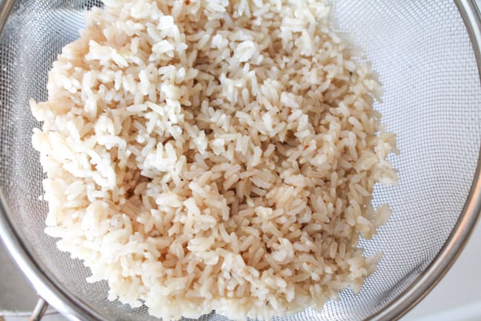 Perfectly cooked brown rice in a sieve