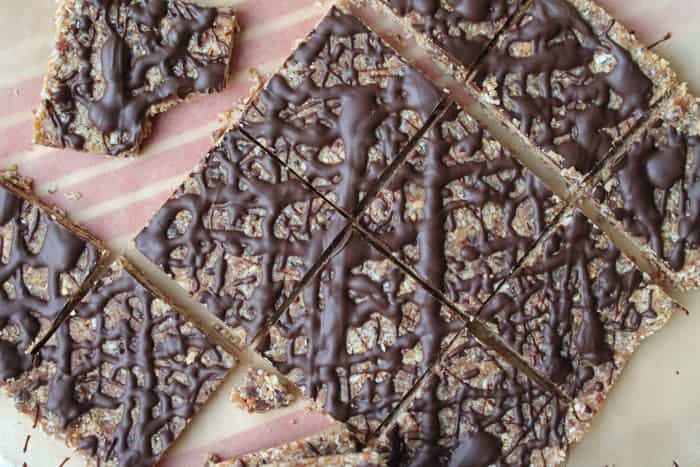 Roasted Almond Date Squares shown cut on a board