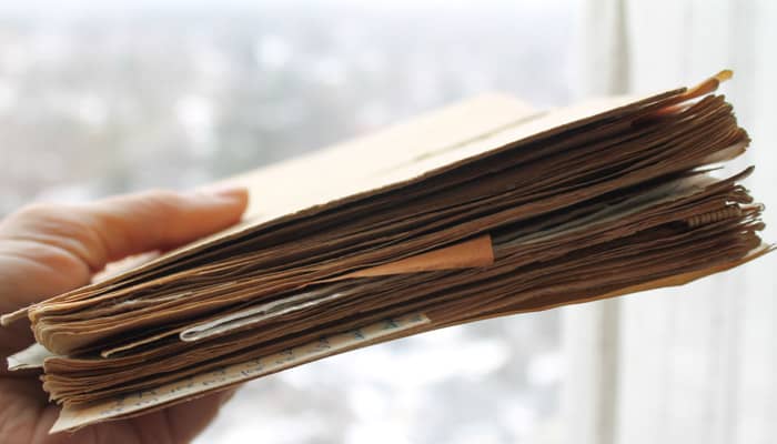 a hand holding a homemade recipe book