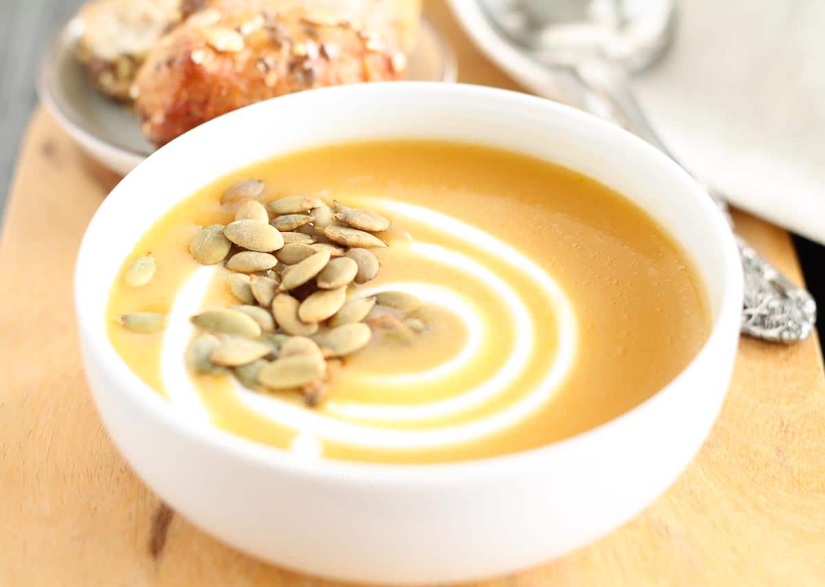 bowl of butternut squash soup garnished with pumpkin seeds
