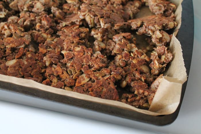Sugar Free Granola being baked on a sheet lined with parchment paper