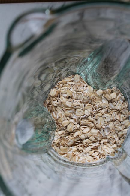 gluten free oats in a blender about to be processed into flour