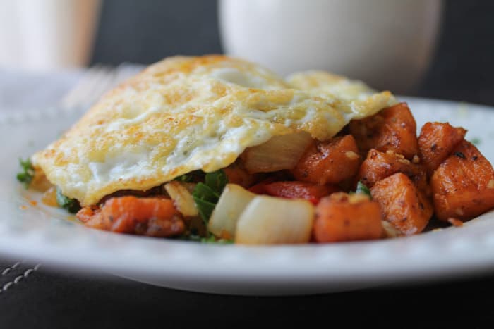 Sweet Potato Hash with Eggs on a white plate