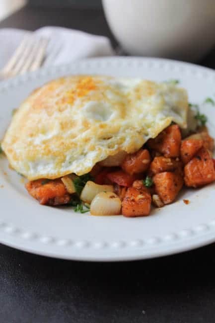 Sweet Potato Hash with Eggs on a white plate