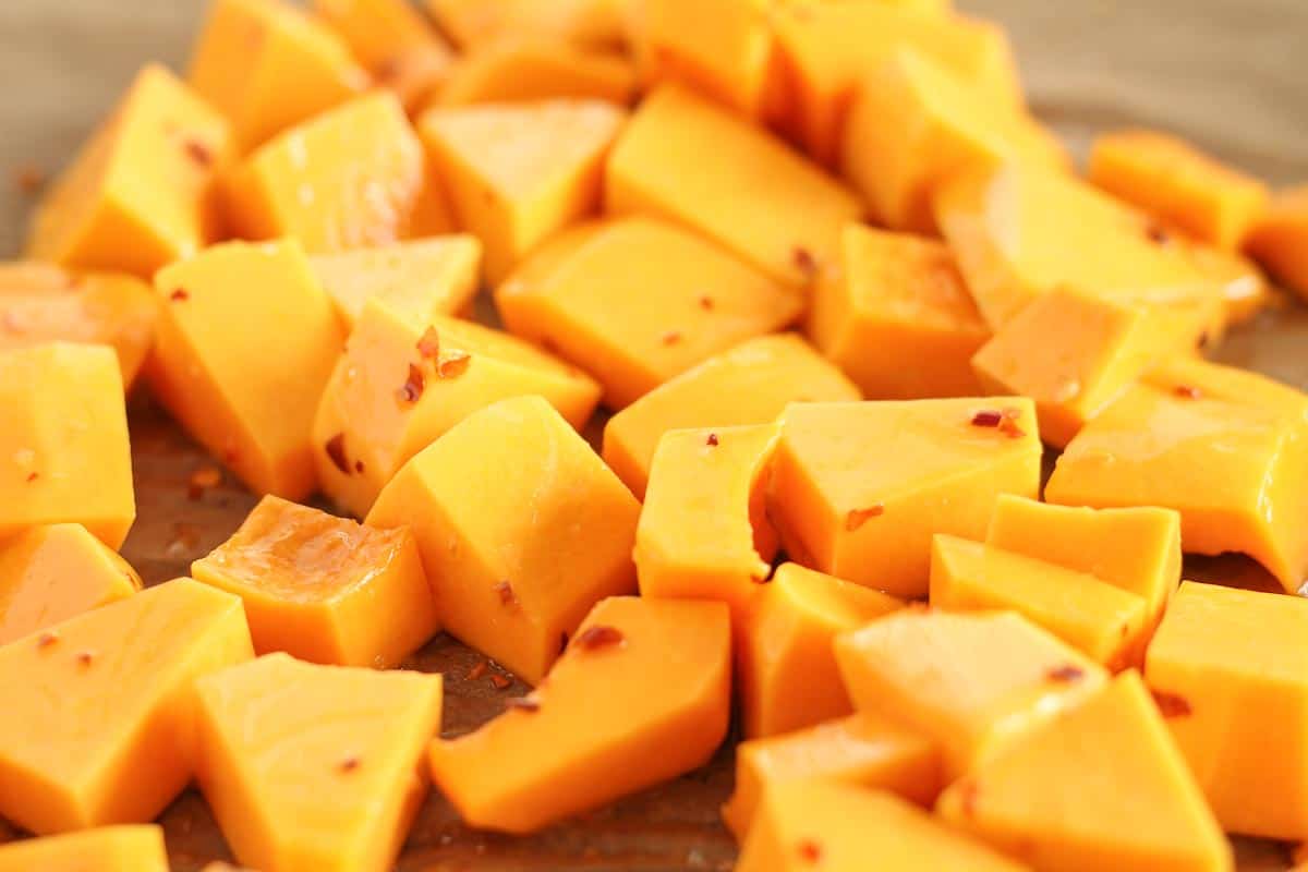 chopped butternut squash on a baking sheet