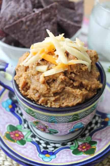 a colorful Mexican mug filled with Homemade Refried Beans