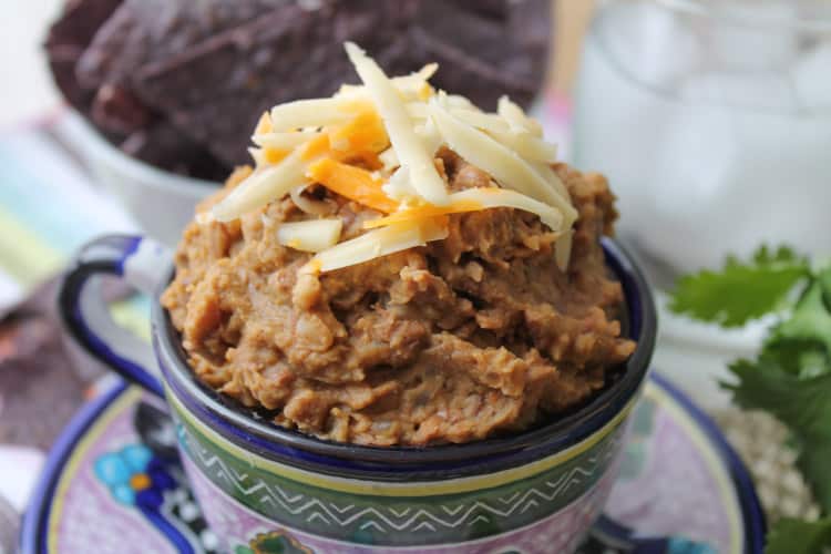 a colorful Mexican mug filled with homemade refried beans