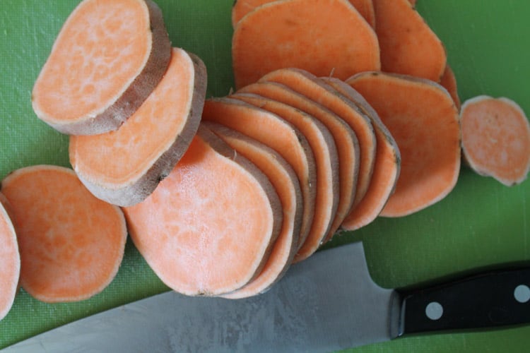 sweet potatoes sliced on a cutting board