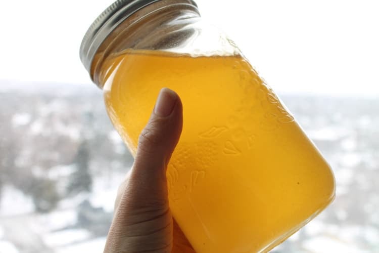 a hand holding a jar of local honey