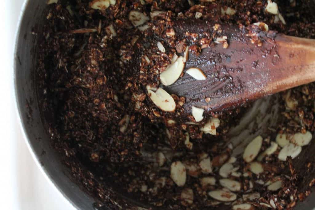 chocolate mixture being stirred with a wooden spoon