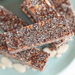 healthy chewy granola bars stacked up on a plate