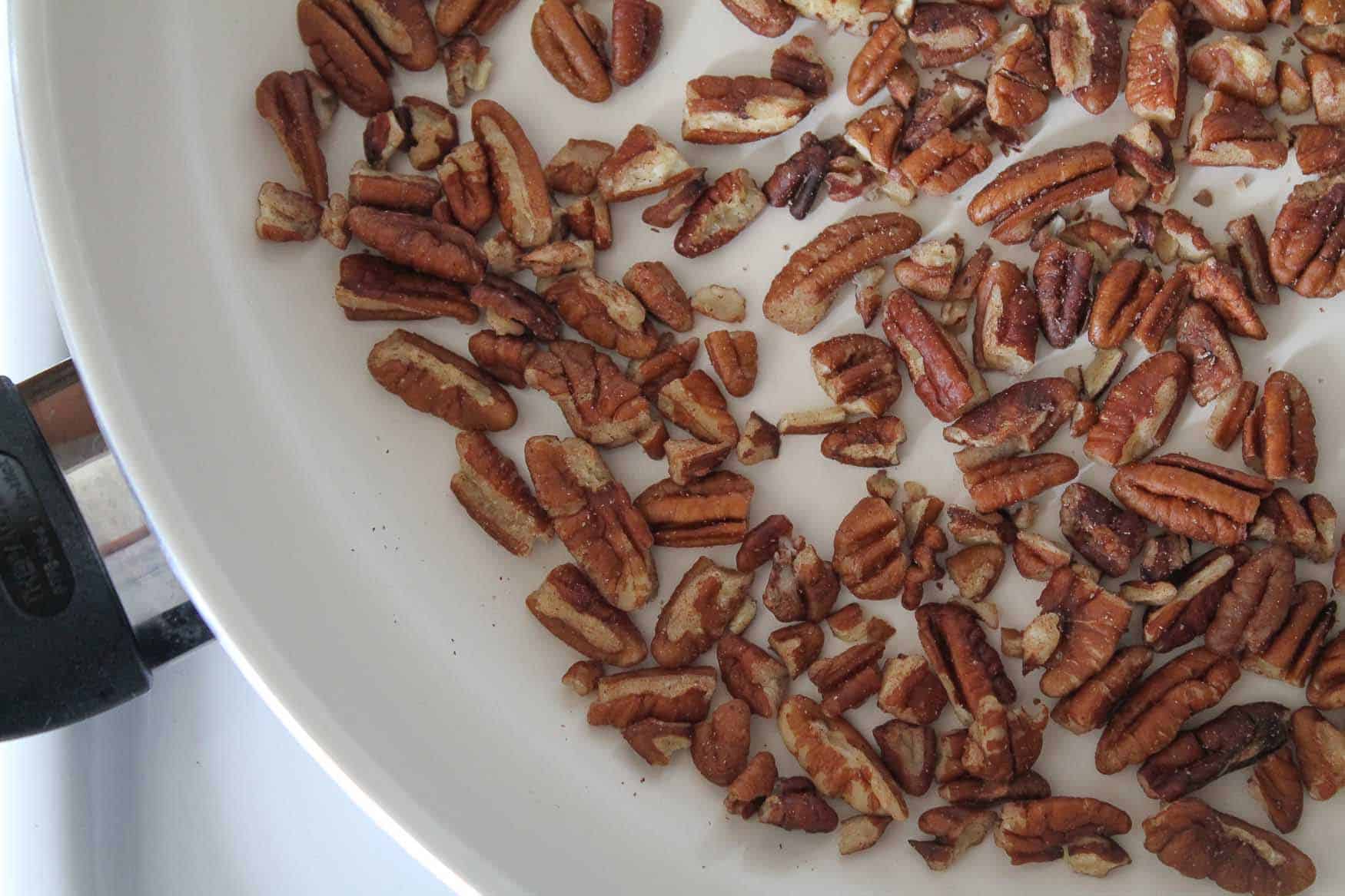 pecans toasting in a pan.