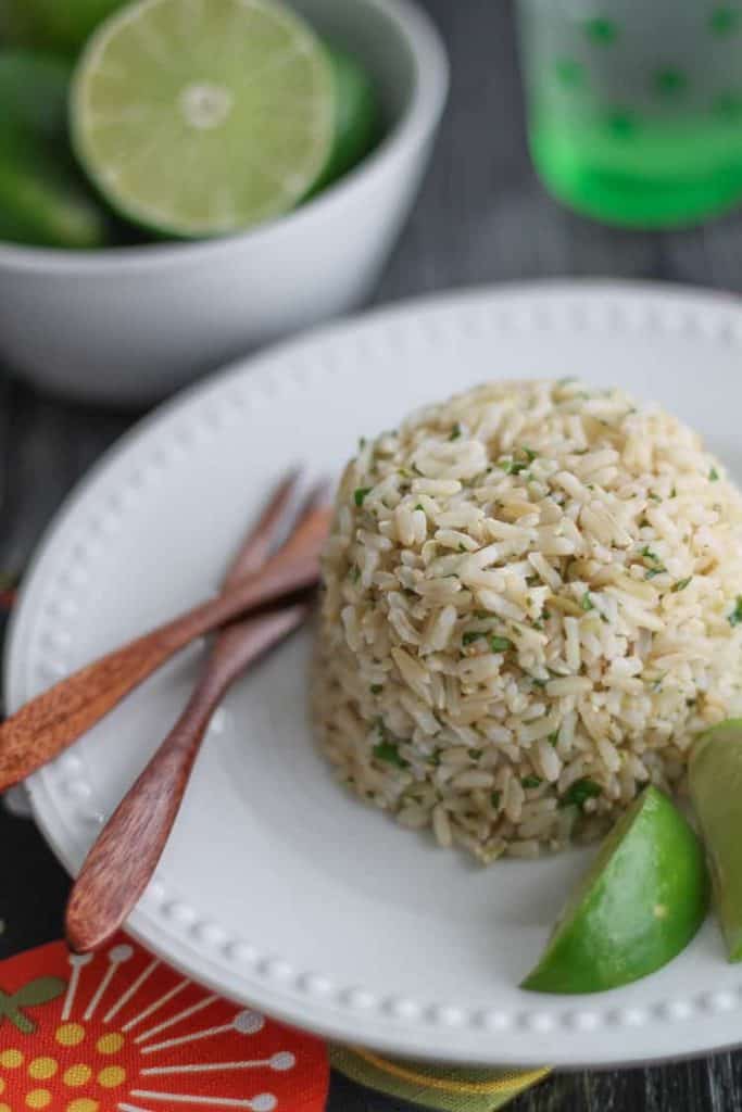 healthy rice on a plate garnished with fresh sliced limes