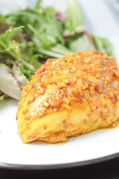 baked chicken on a plate with salad