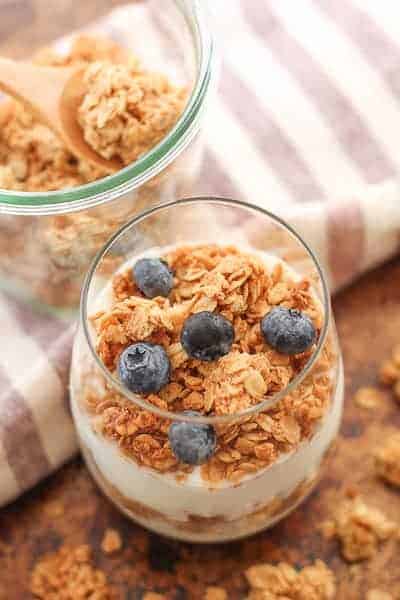 Gluten Free Granola layered with yogurt in a glass an topped with fresh blueberries