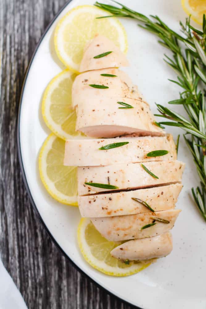 a plate of slice lemon rosemary chicken.