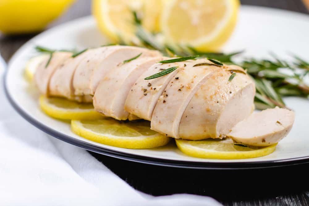 a plate of slice lemon rosemary chicken.