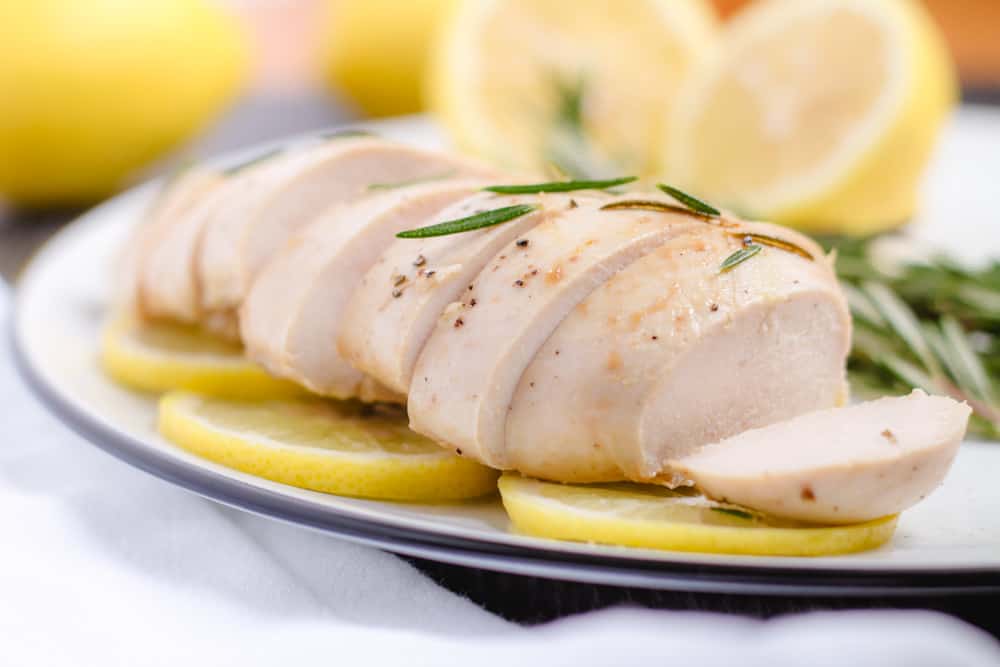 a plate of slice lemon rosemary chicken.