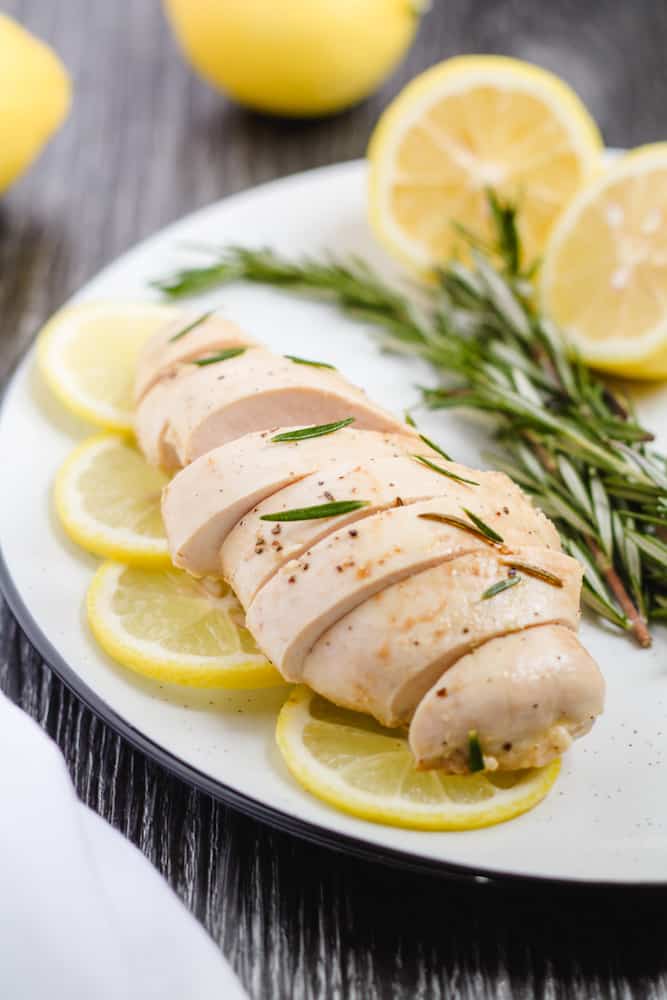 a plate of slice lemon rosemary chicken.