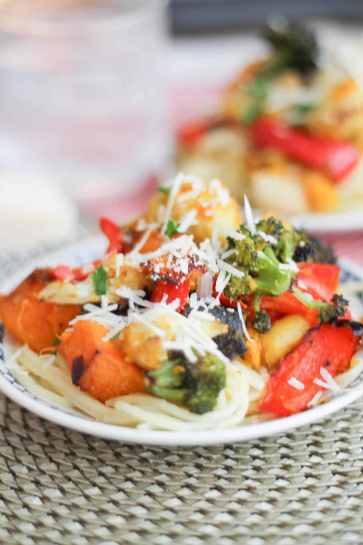 Roasted squash, broccoli, cauliflower on top of a bed of gluten free brown rice noodles.