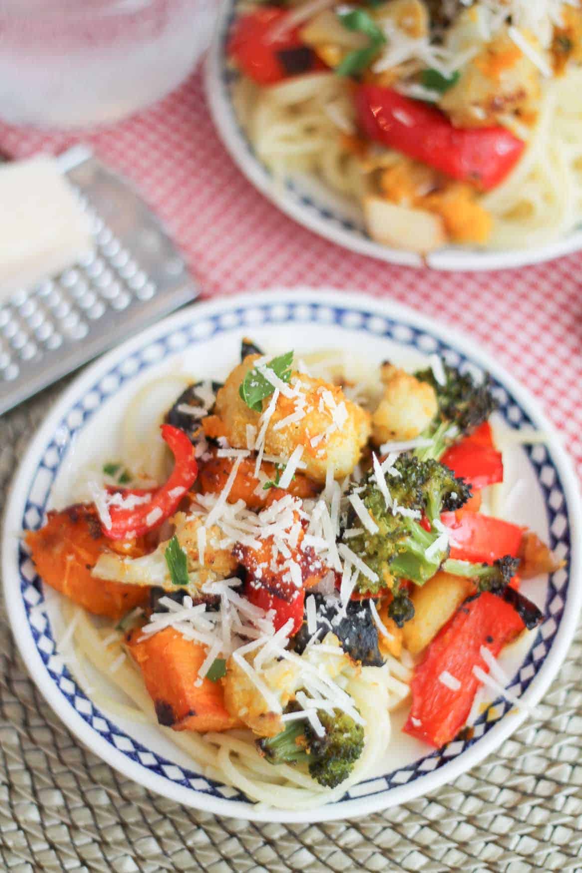 Roasted squash, broccoli, cauliflower on top of a bed of gluten free brown rice noodles.