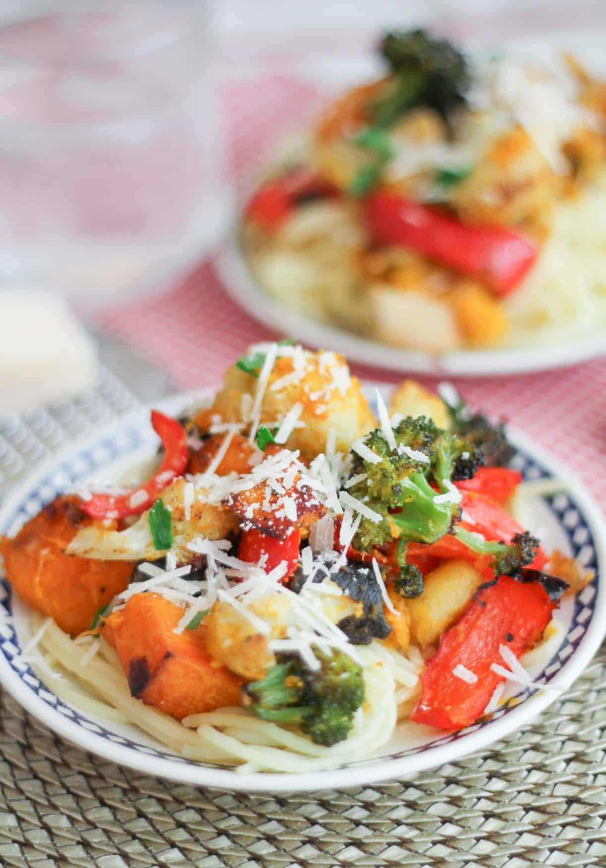 Roasted squash, broccoli, cauliflower on top of a bed of gluten free brown rice noodles.