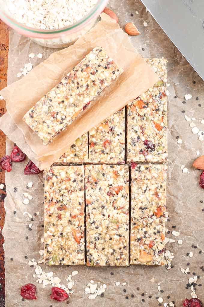 Healthy Fruit Nut and Seed Bars. These delicious granola bars feature dates, cranberries, almonds and almost every seed you can think of! Pumpkin seeds, hemp seeds, chia seeds, sesame seeds, black sesame seeds, this recipe has them all. Naturally sweetened, vegan and gluten free. #healthysnacks #glutenfree #veganrecipe