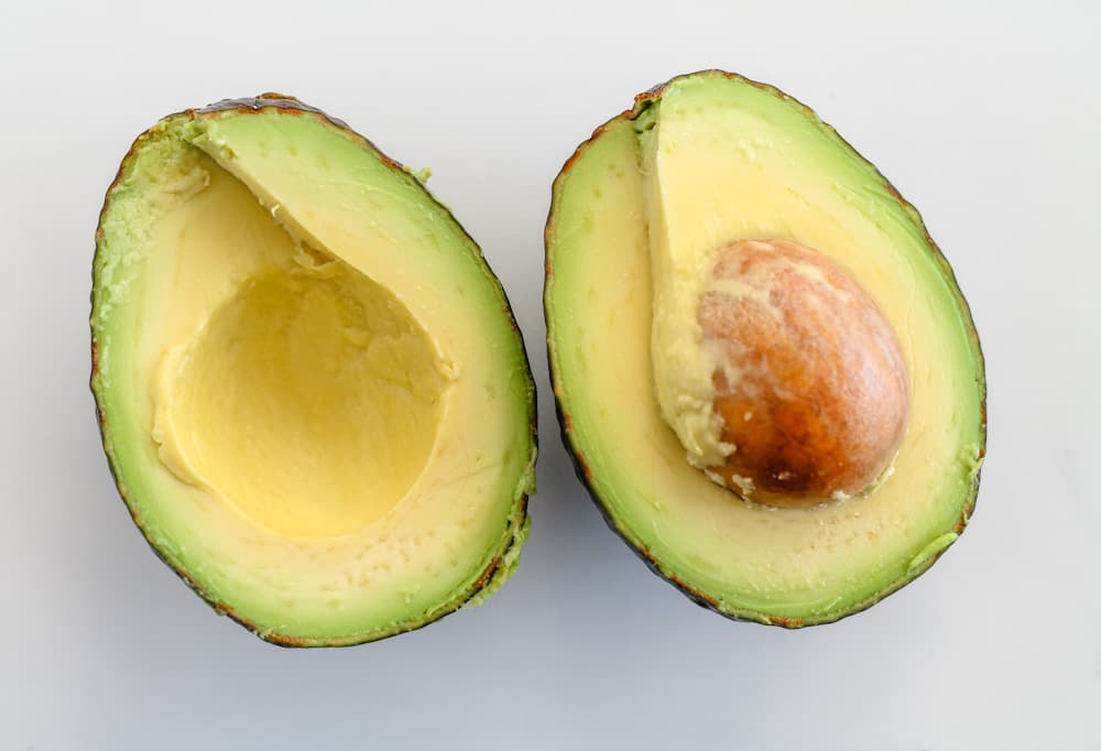 a fresh avocado sliced in half.