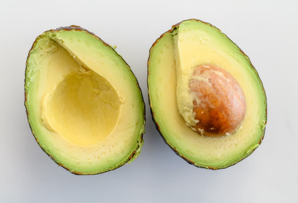 A ripe avocado on a cutting board.