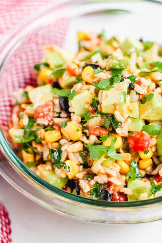 a bowl of cowboy caviar salad topped with fresh cilantro.