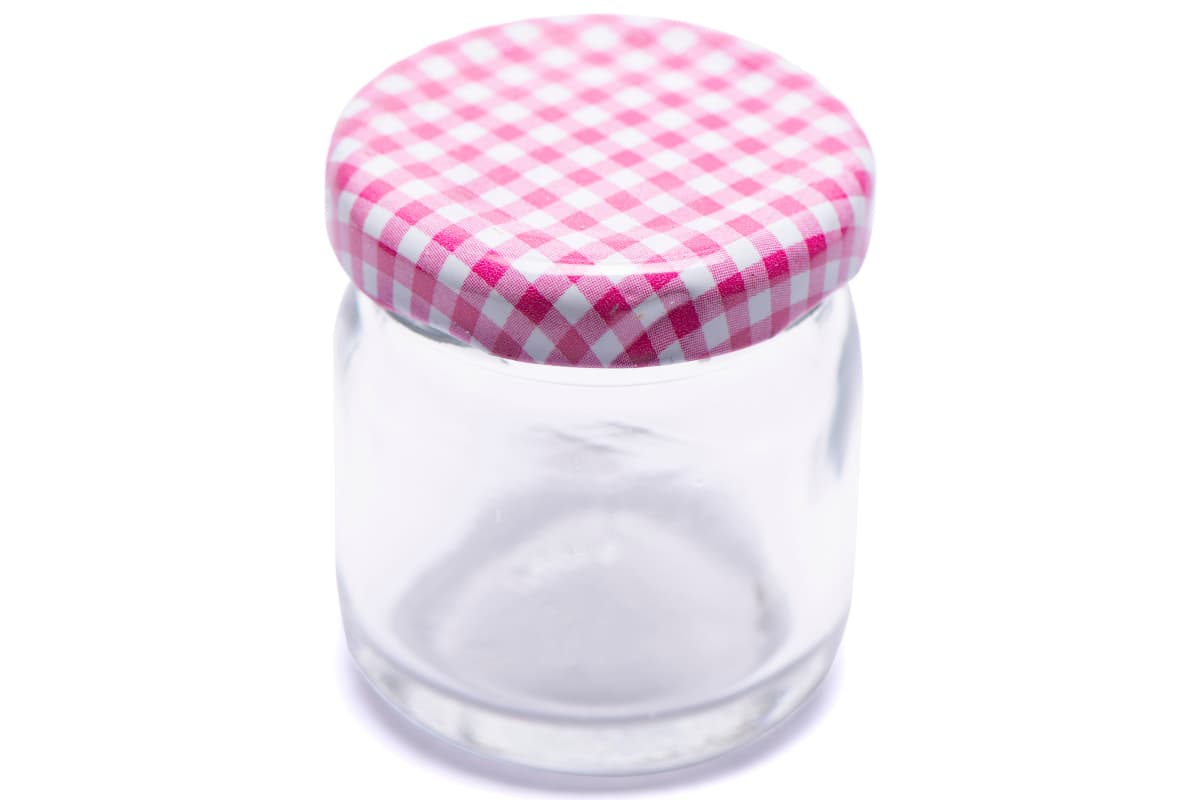 a small glass mason jar with a lid.