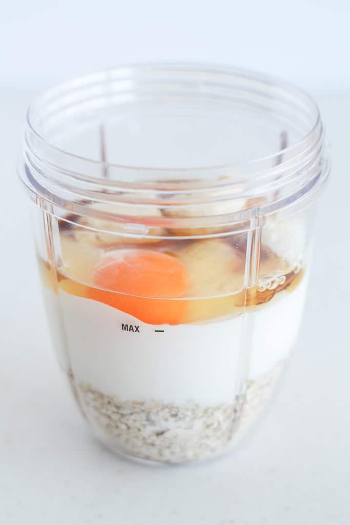 oats, yogurt, egg, and banana in a blender cup
