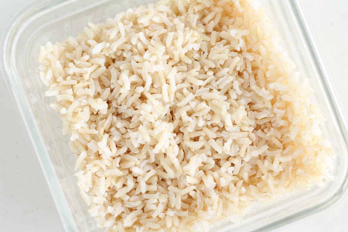 cooked brown rice in a glass container