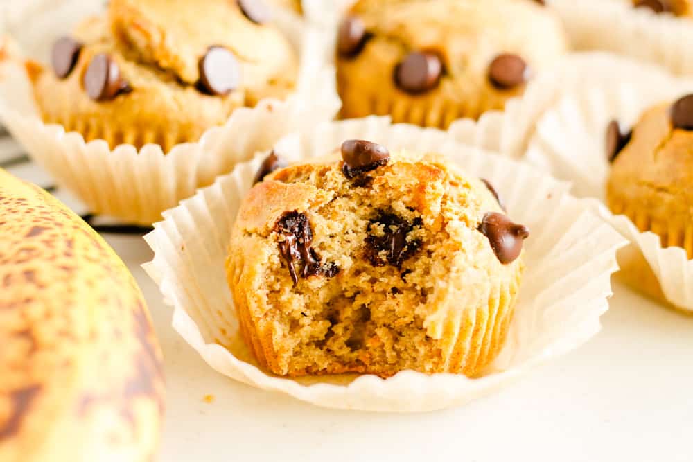 A gluten free banana muffin with a bite out of it.