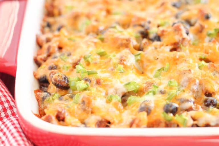 Tex mex casserole in a baking dish with bubbling cheese on top.