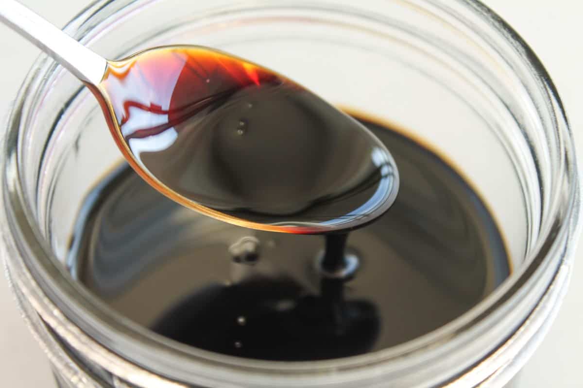 A spoon in a jar of homemade dressing.