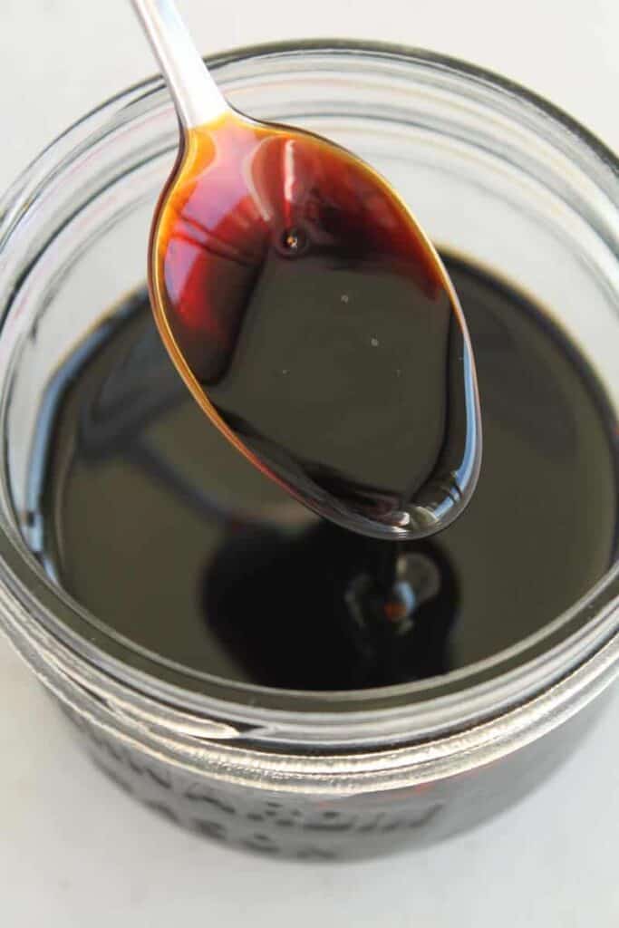s spoon in a jar of homemade balsamic glaze