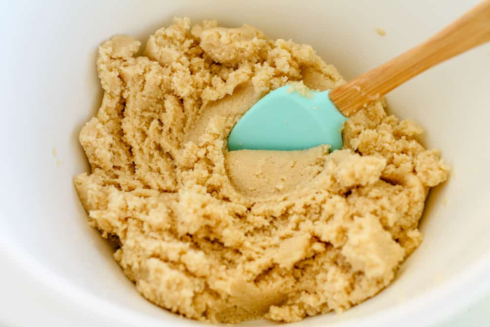 cookie dough being stirred with a spatula.