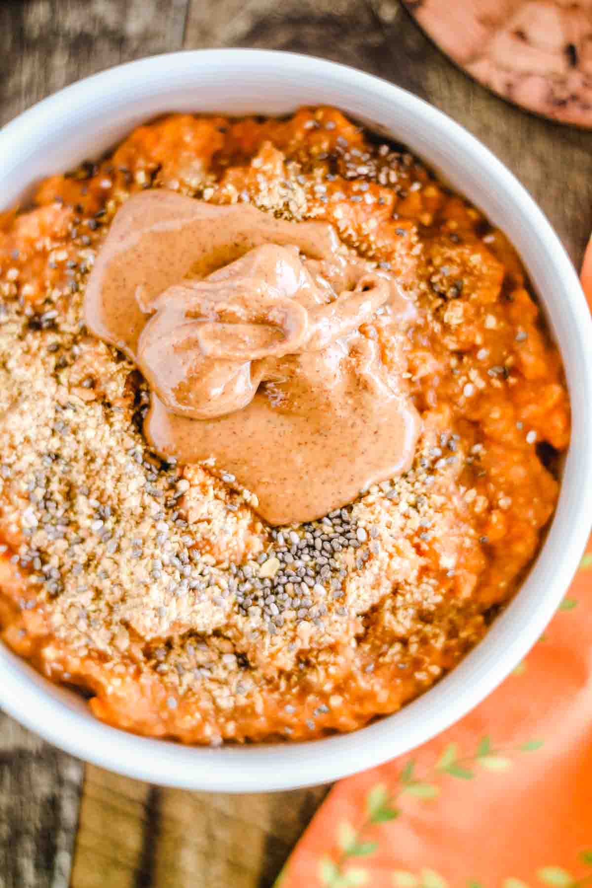 a sweet potato breakfast bowl topped with ground flax seed and chia seeds