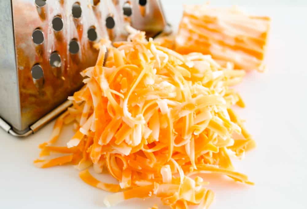 shredded cheese and a cheese grater.