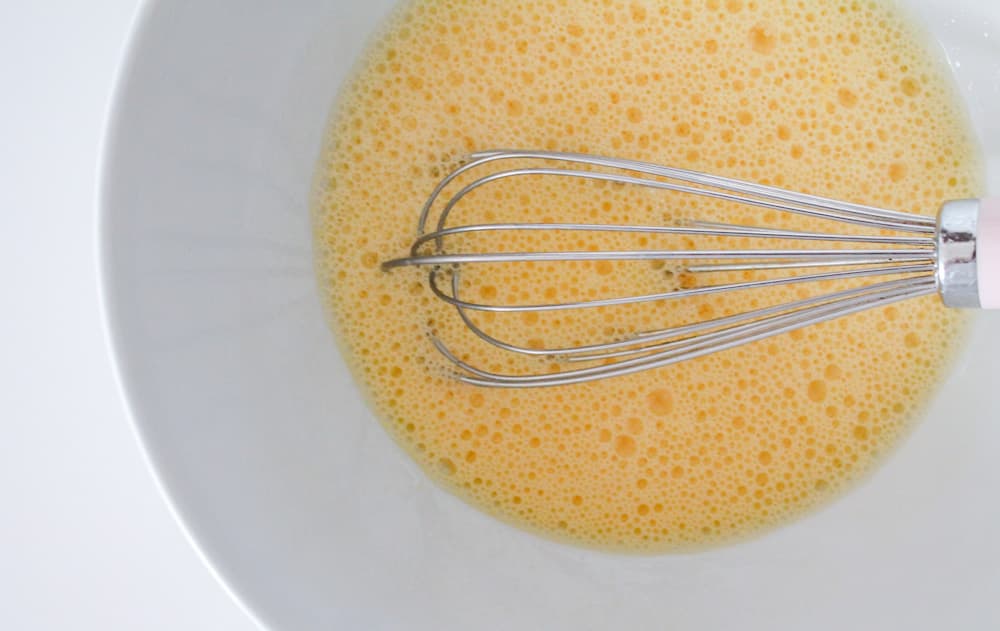 whisked eggs in a large mixing bowl.