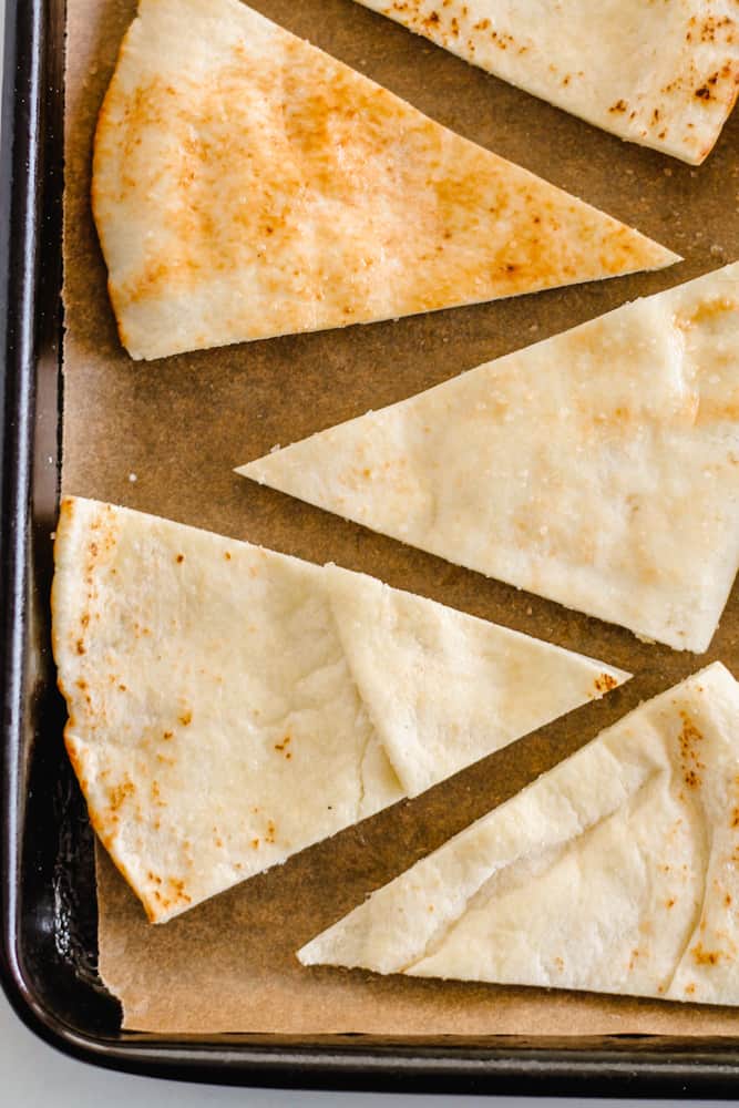 pita bread wedges on a baking sheet.