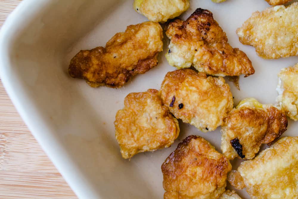 cooked breaded chicken in a casserole dish.