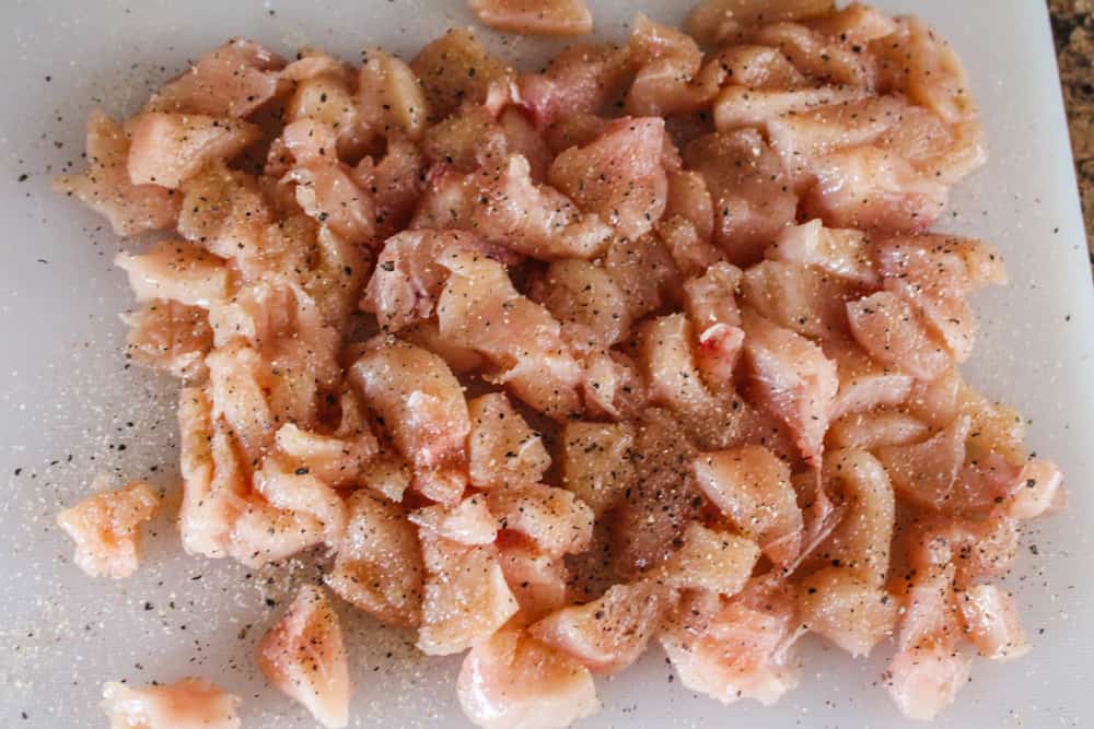 chicken pieces cut up on a chopping board.