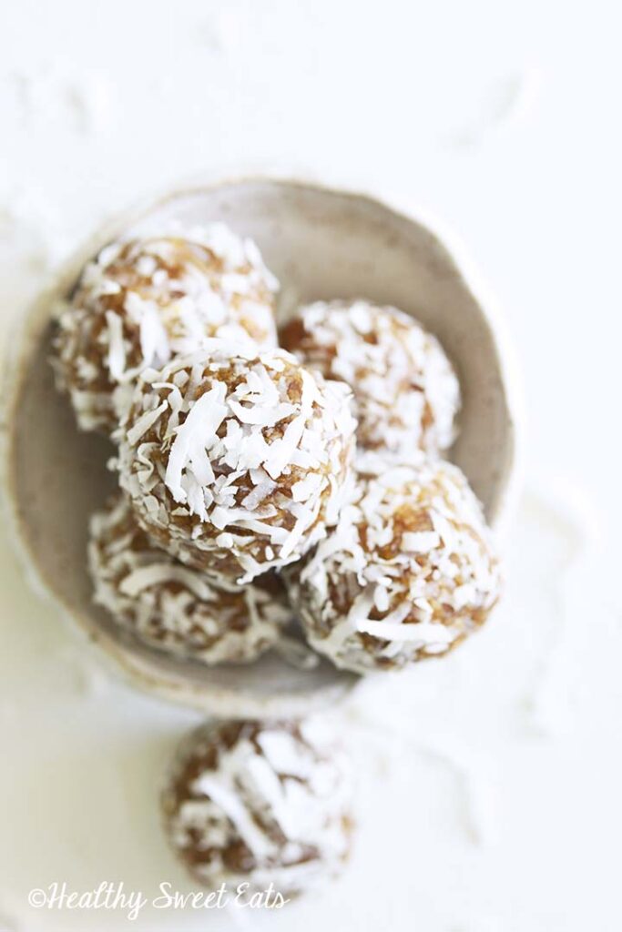 a bowl of coconut date balls.