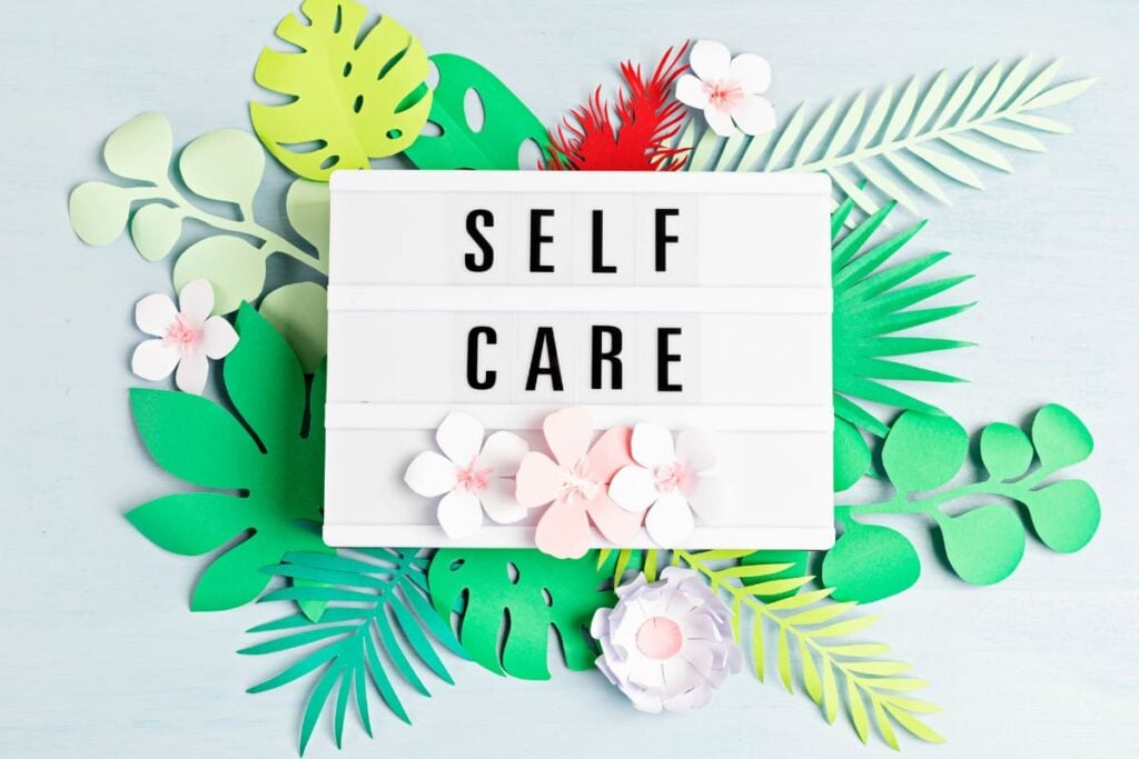 a board with the words self care on it.