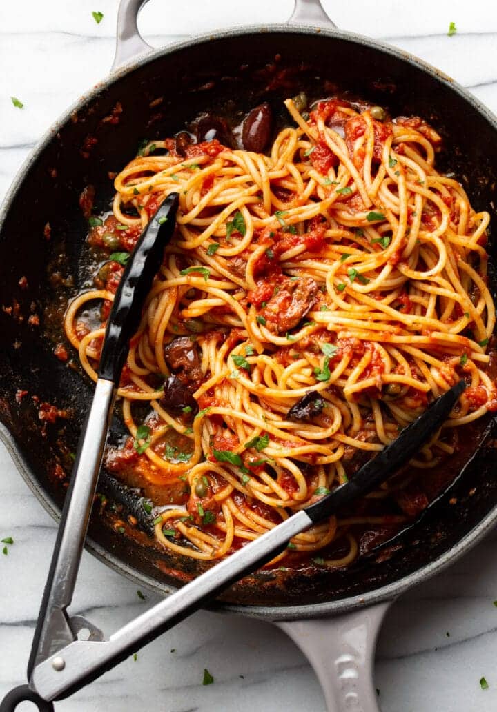 pasta puttanesca in a dish.
