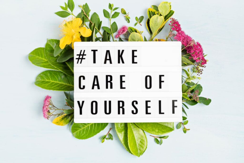 a board with take care of yourself written on it for a self care ideas post.