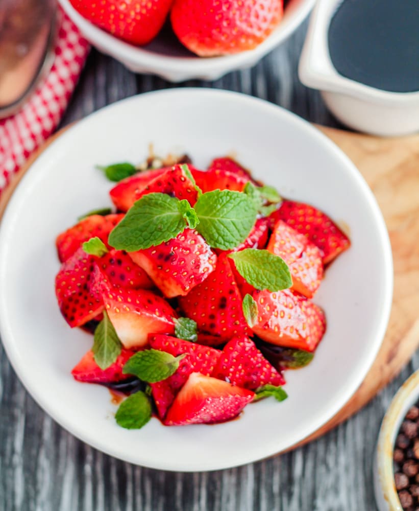 a dish of balsamic strawberries with mint.
