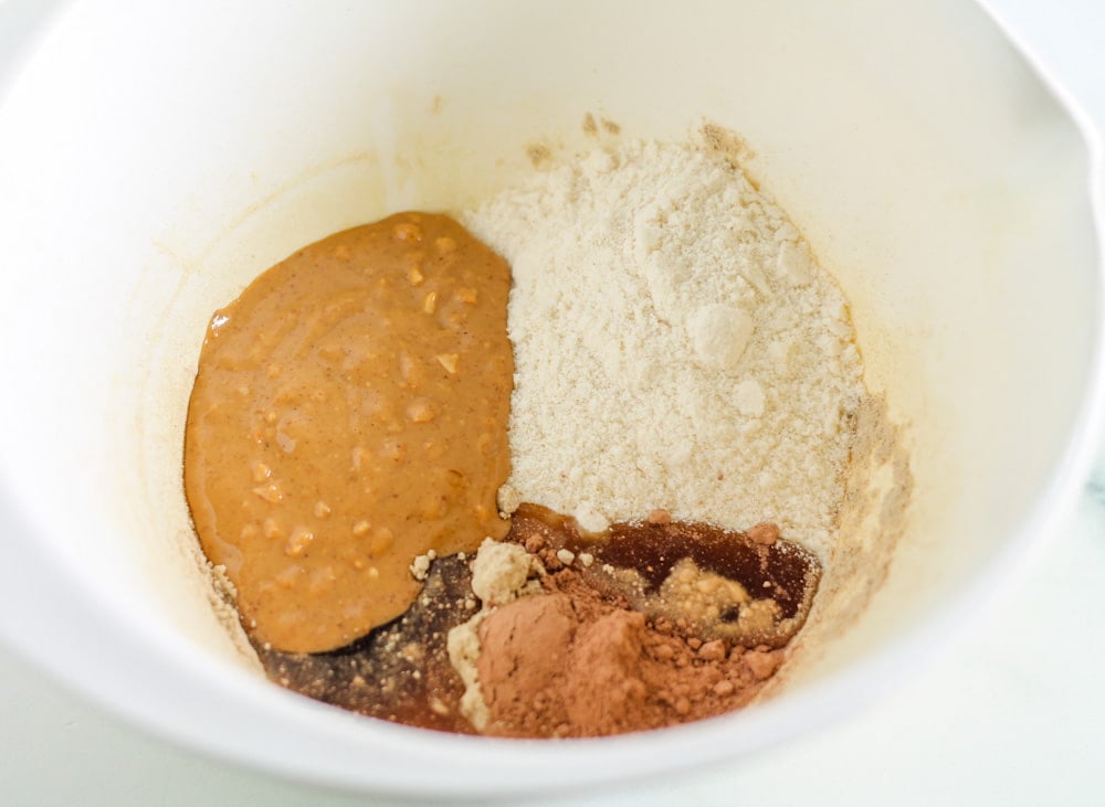 chocolate protein bar ingredients in a mixing bowl.